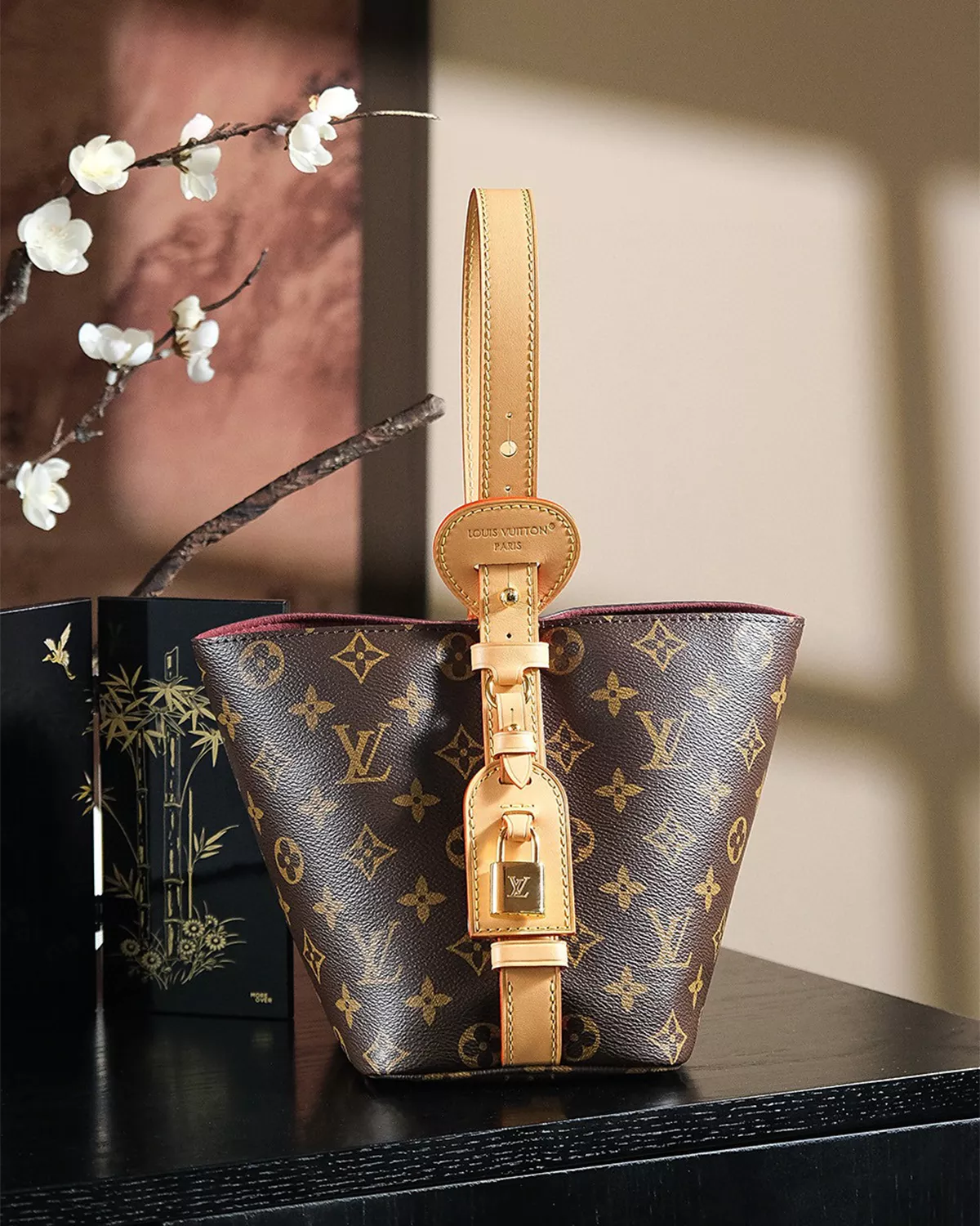 Rebce All In BB monogram canvas crossbody bag with gold hardware and foldable design.