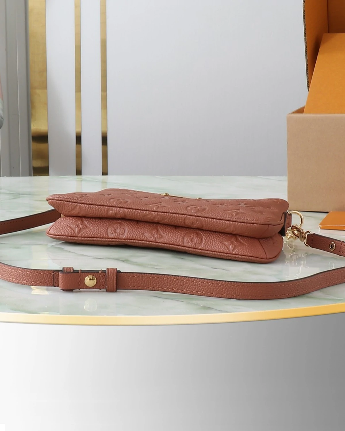 Liv Pochette “Monogram Empreinte Leather Cognac ”