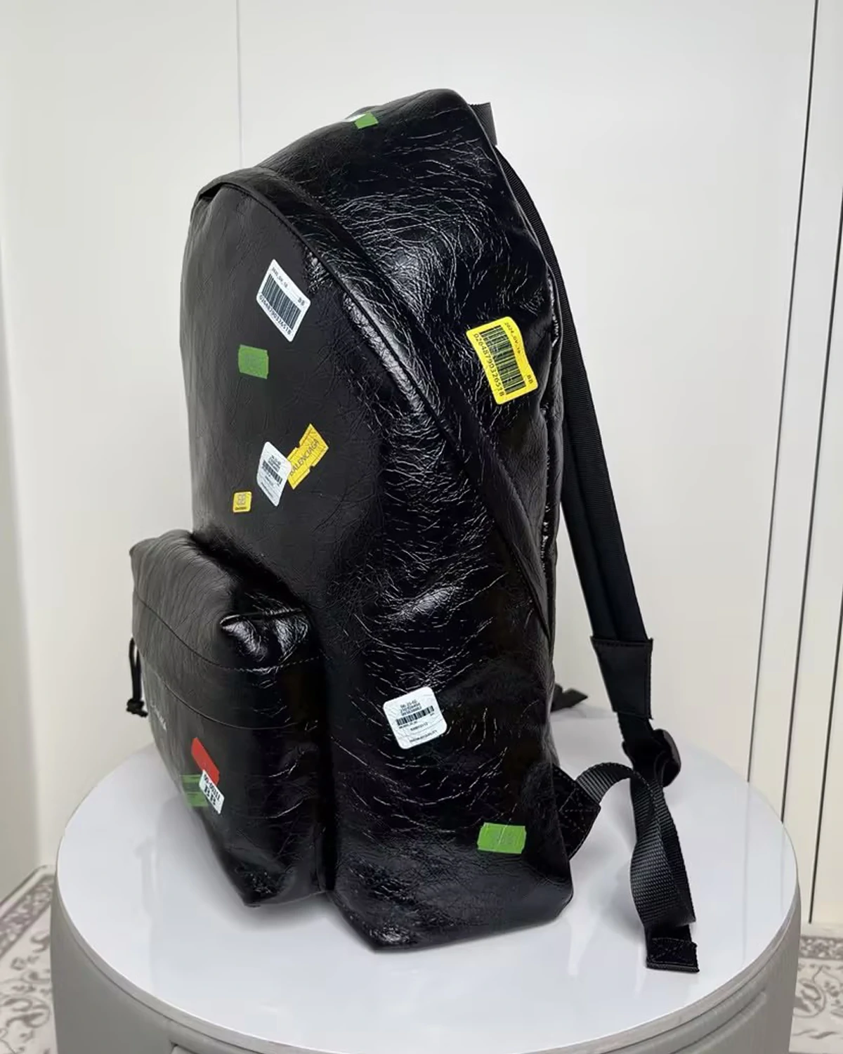 black-leather-explorer-backpack-with-printed-stickers (1)