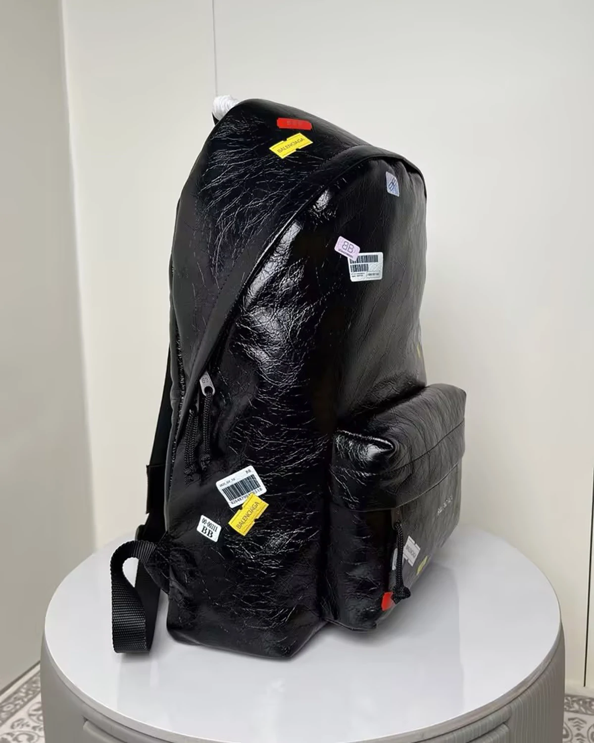 black-leather-explorer-backpack-with-printed-stickers (1)